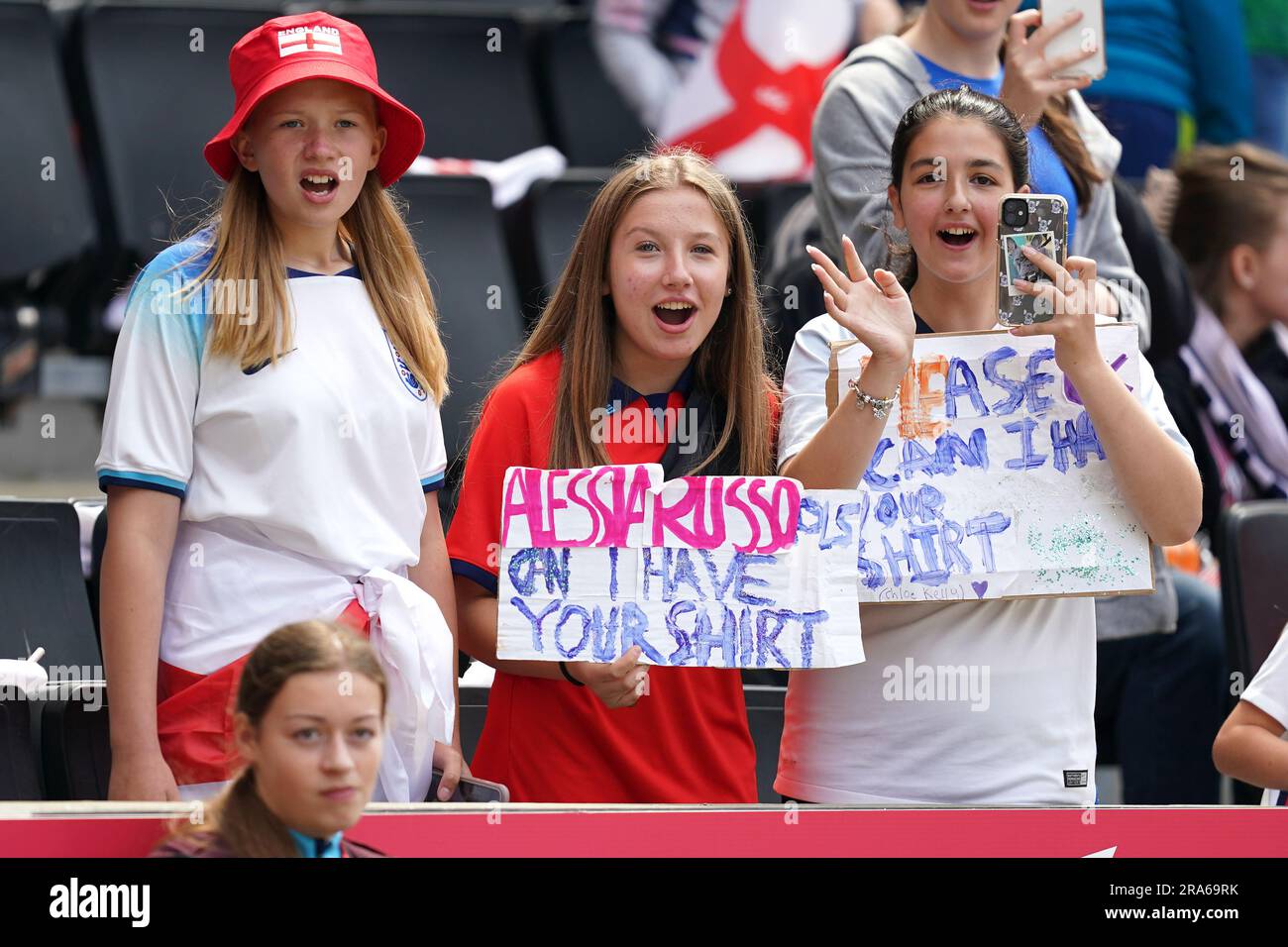 Young England fans hold up signs for the players before a Women's