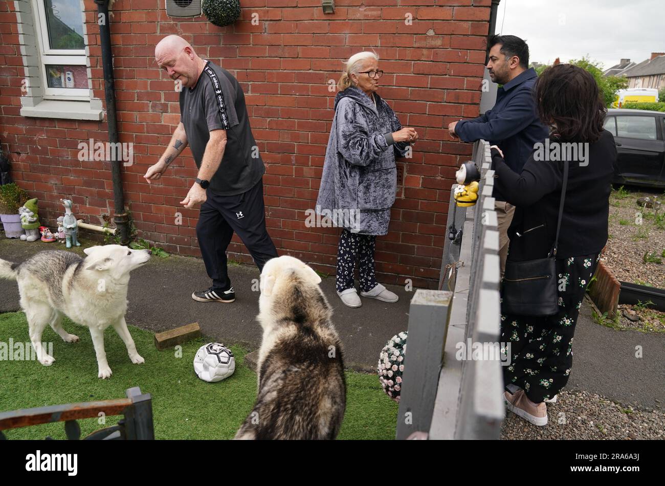 First Minister Humza Yousaf chats with locals whilst handing out