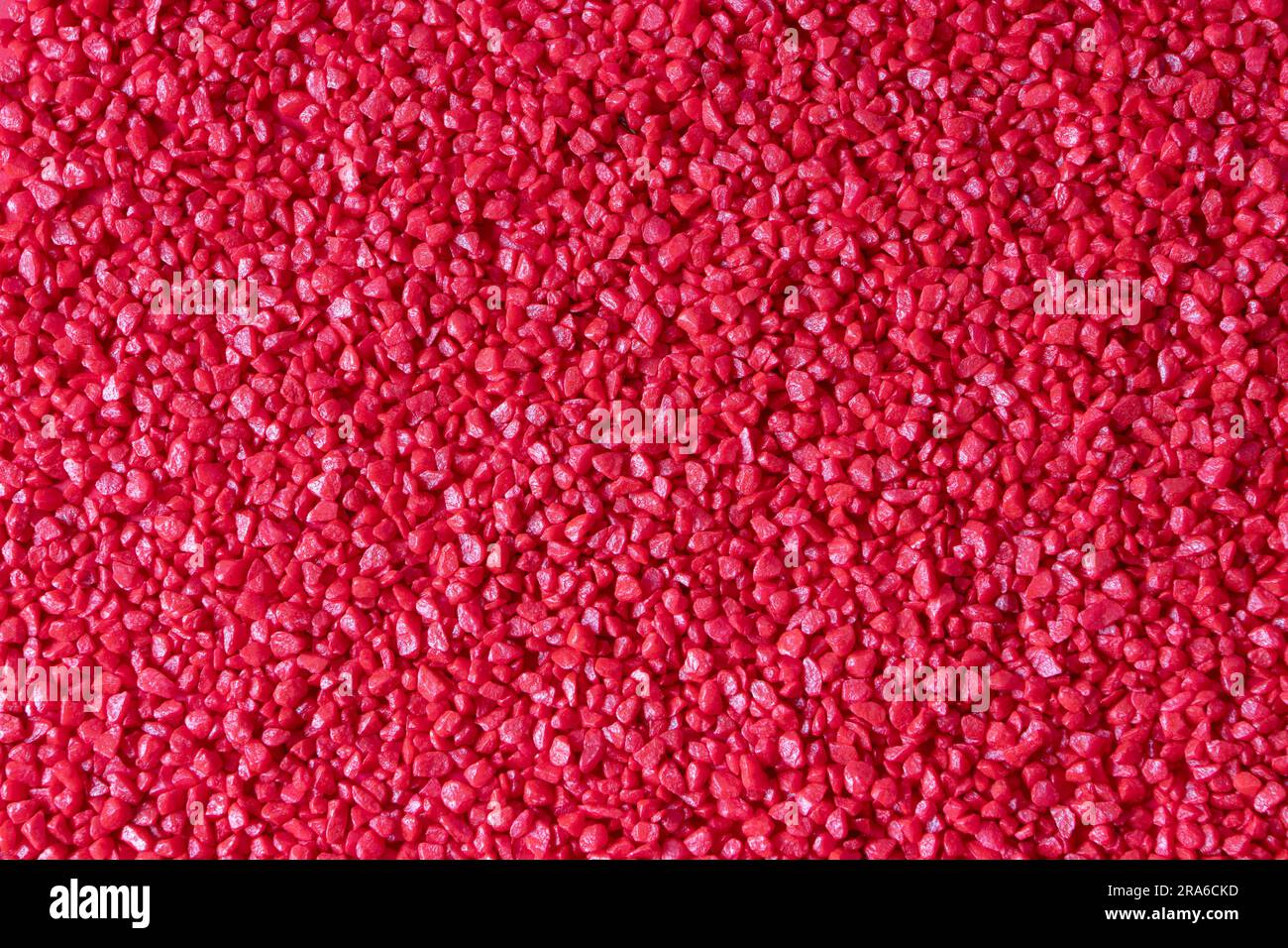 Red decorative glossy floristic stones background. Small size natural
