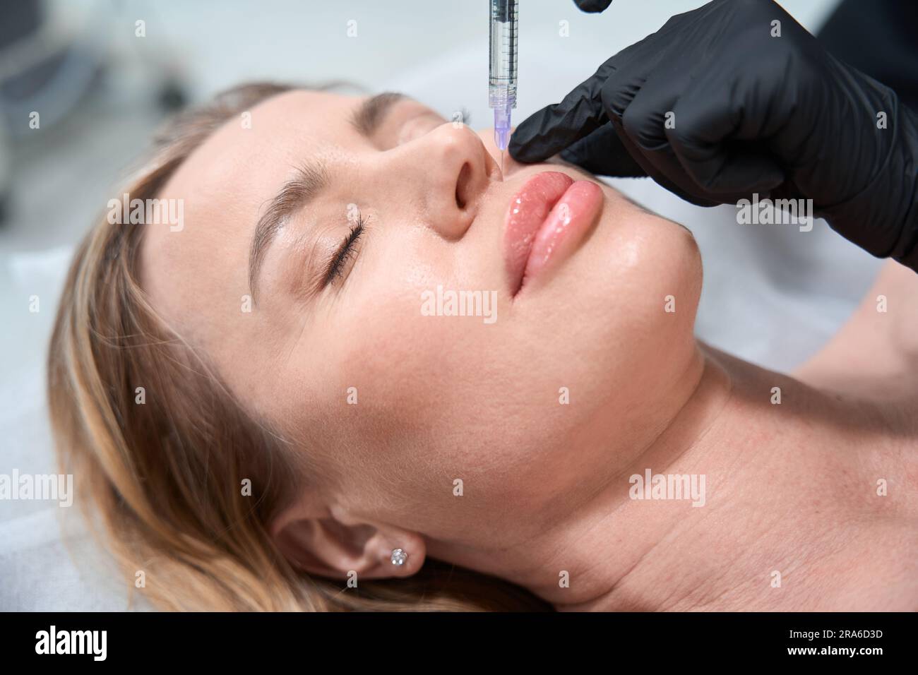 Cosmetologist makes beauty injections to a blonde client Stock Photo