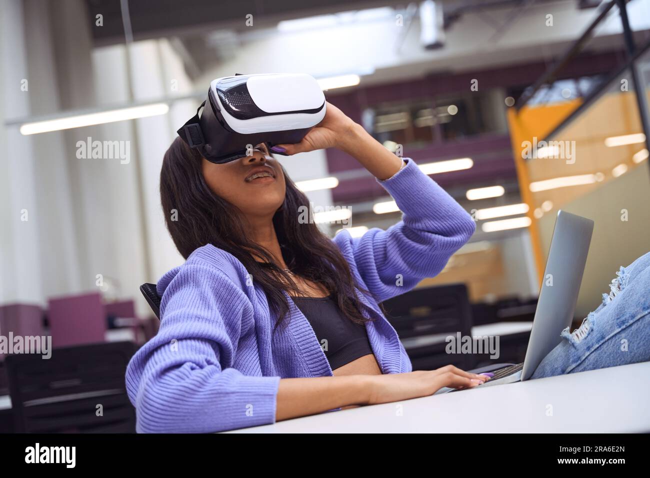 Pretty female using vr technologies in modern room Stock Photo