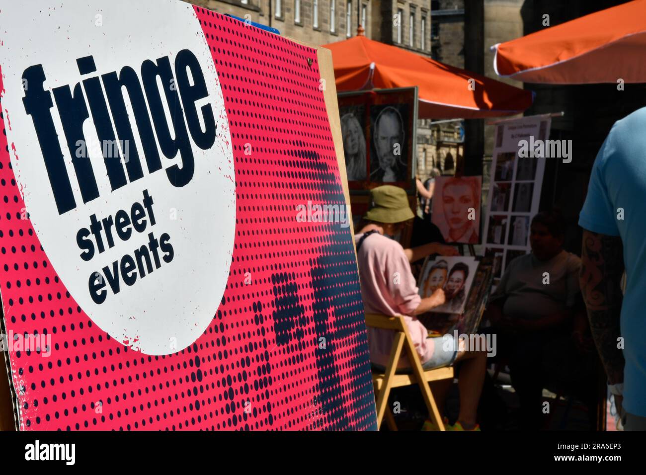 A Caricature Artist Working On The Royal Mile, Edinburgh, Scotland During The Edinburgh Fringe