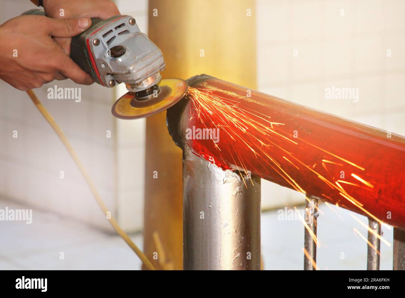 Use the grinder handle to adjust the steel walkway railing without