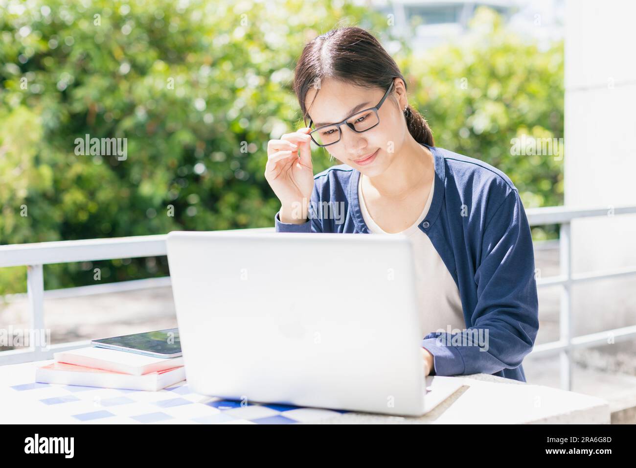 Asian teen girl with laptop computer for online education learning or programmer student in university. Stock Photo