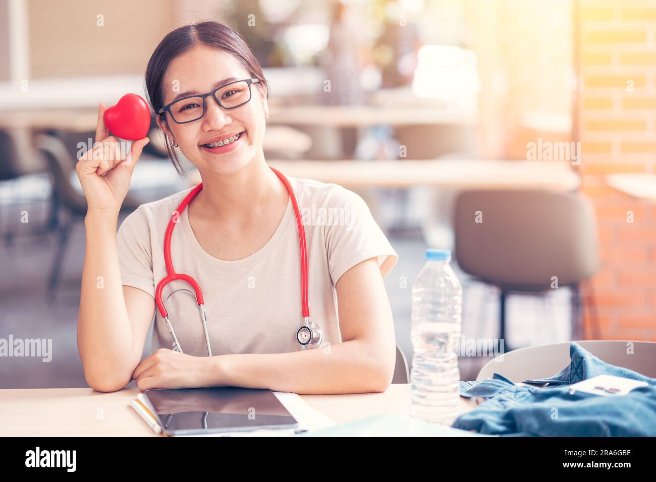 Happy cardio doctor student with red heart sign for sharing love healtcare to people concept. Stock Photo