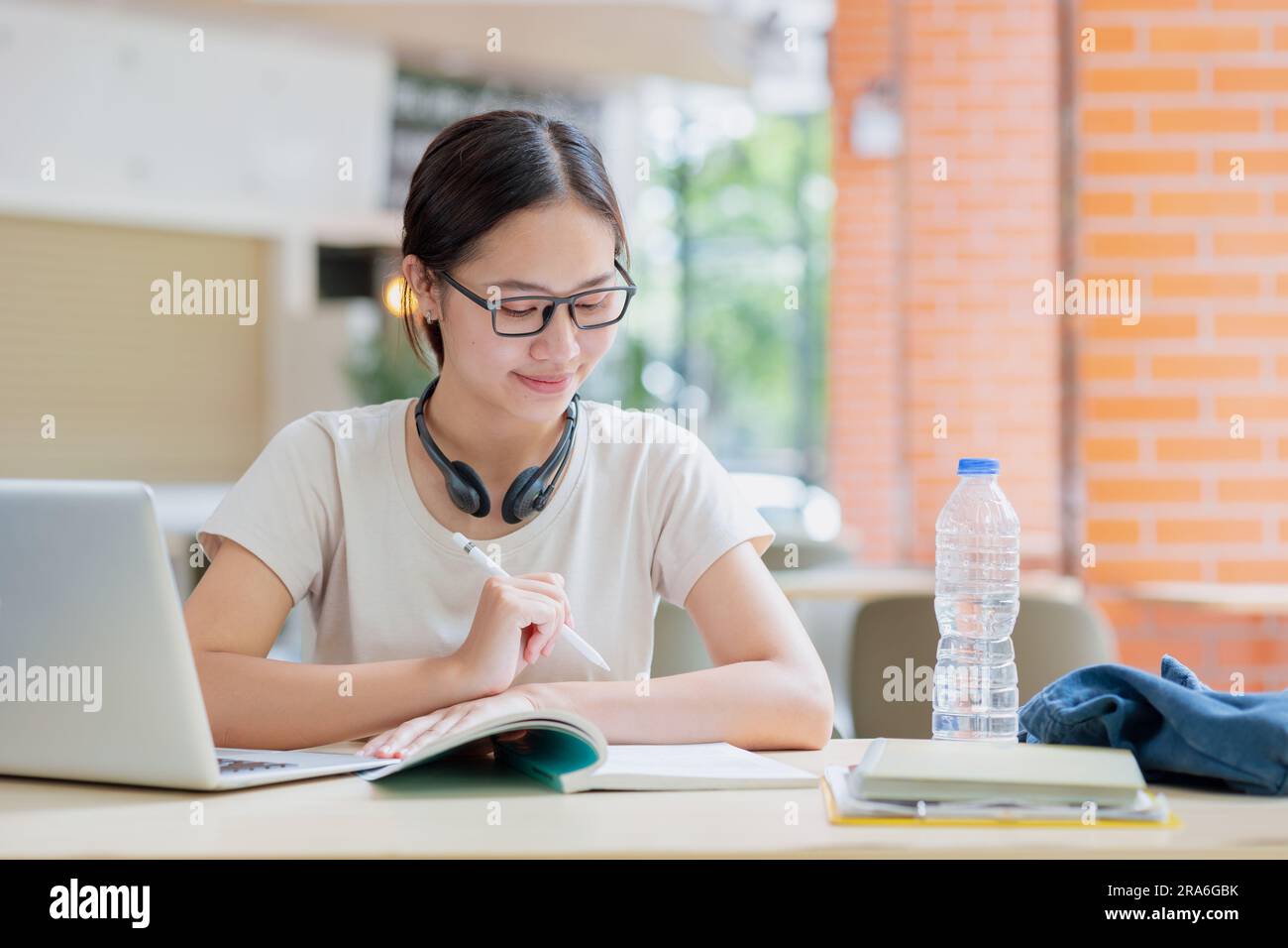 Asian university teen woman review reading a book education learning smart student lifestyle. Stock Photo