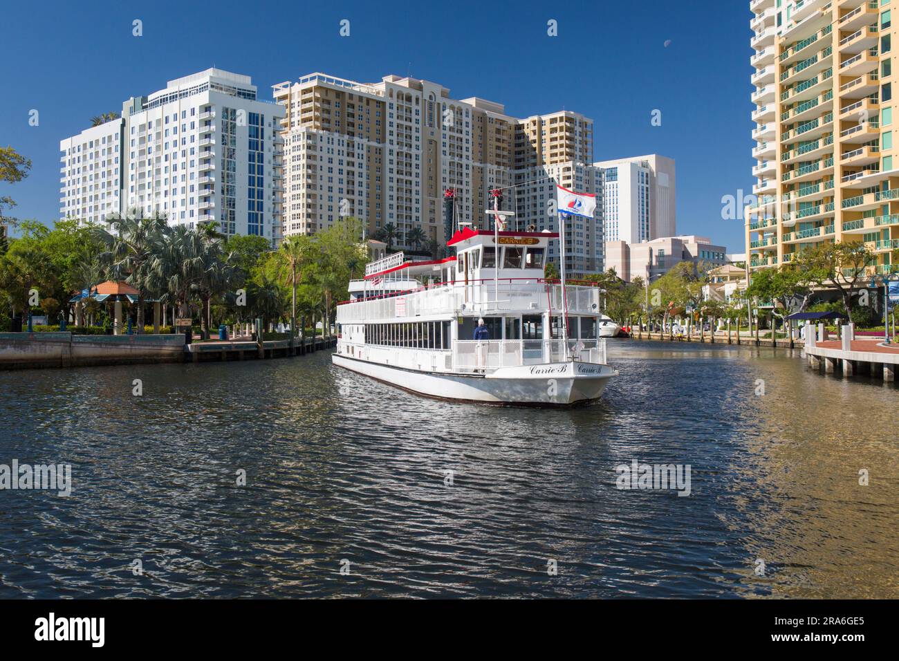 Fort Lauderdale, Florida, USA. Iconic paddleboat, the Carrie B, dwarfed by high-rise Downtown condominiums lining the New River. Stock Photo