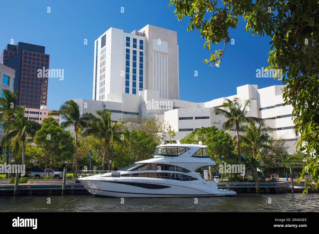 Fort Lauderdale, Florida, USA. View across the New River, luxury motor cruiser moored beneath modern Downtown architecture. Stock Photo