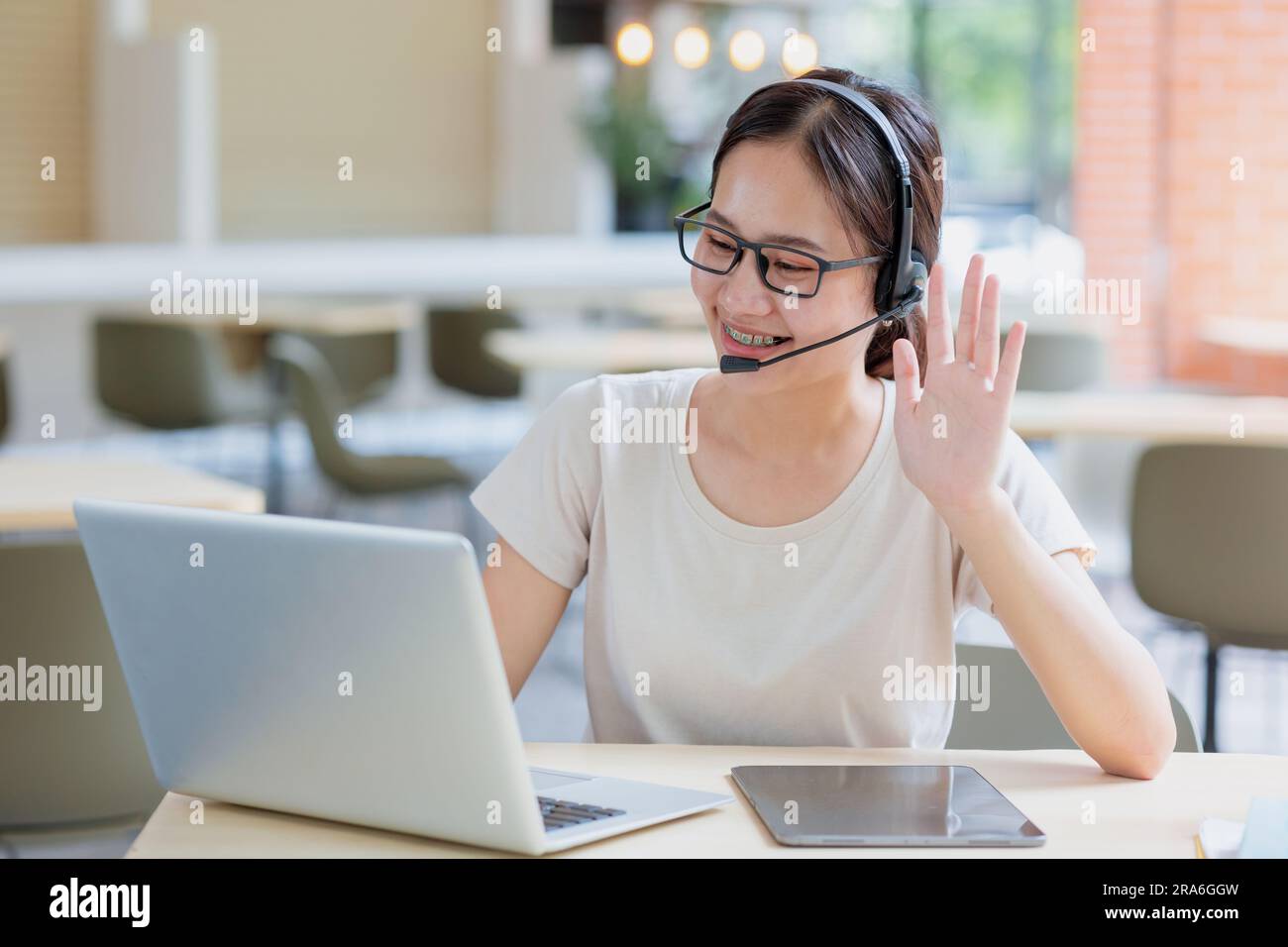 Asian girl student online learning class study online video call zoom teacher, Happy girl talking calling online with laptop. Stock Photo