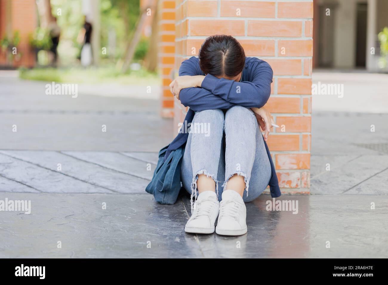 Teen girl sad cry from fail exam. University Student tired sitting down sleep or mental sick Stock Photo