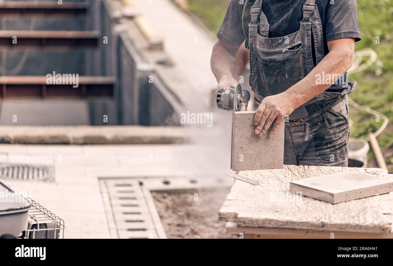 Close up of worker hand using circular saw in the process of cutting