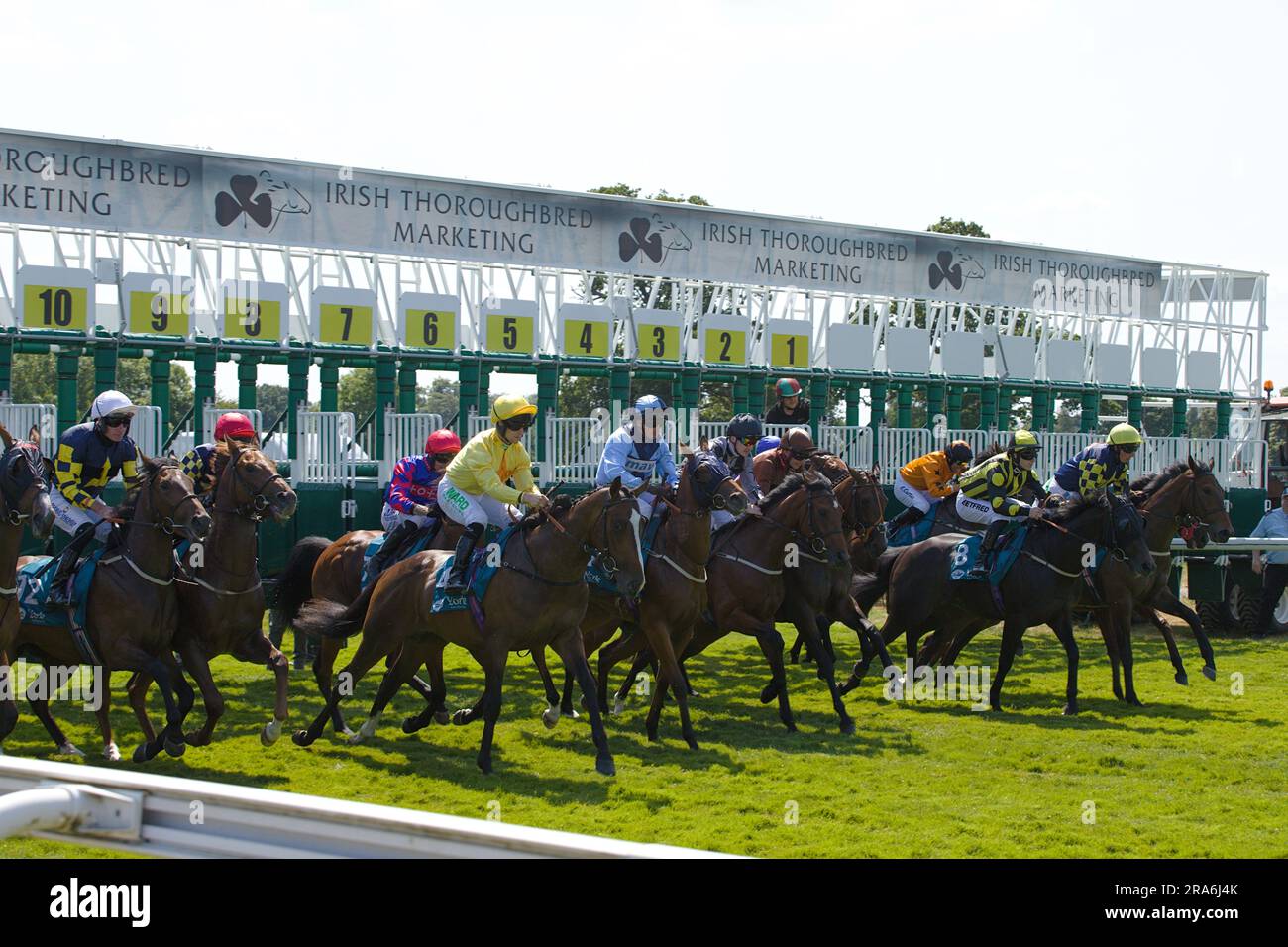 Sequence of jockeys and their horses leaving the starting gates at York Races. Group includes Cam Hardie, Duran Fentiman, Oisin Orr, Ben Robinson, Tom Stock Photo