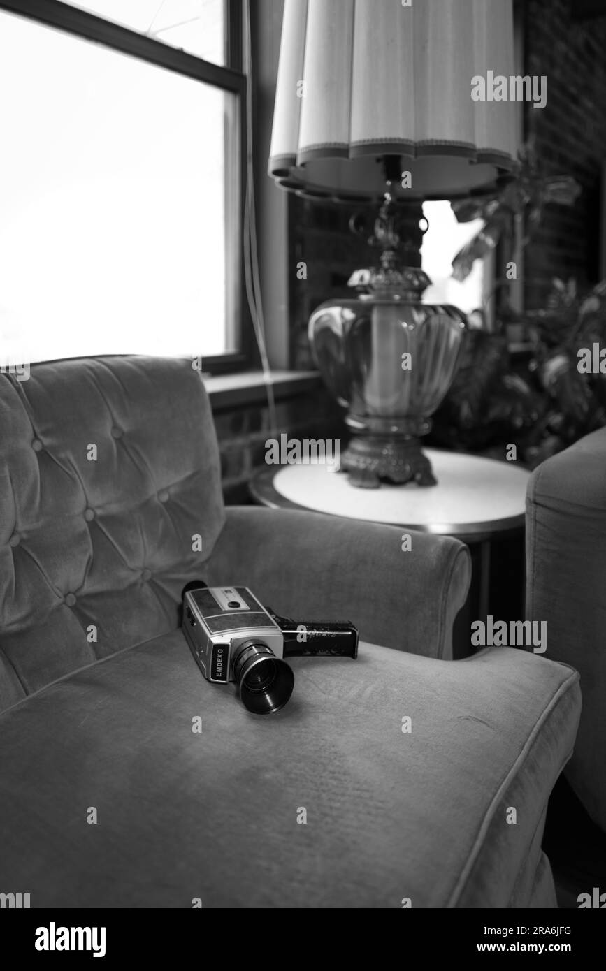 a vintage camera sits on a couch in a loft living room Stock Photo