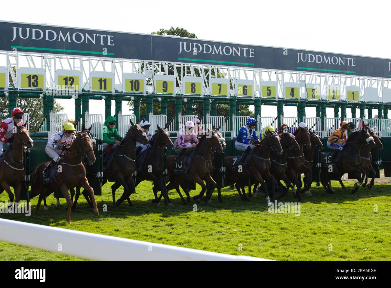 Jockeys and their horses leaving the starting gates during the Juddmonte British EBF Fillies' Restricted Novice Stakes race at York. Stock Photo