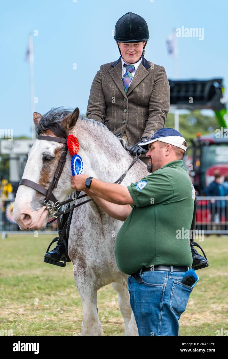 East Lothian, Scotland, UK, 1st July 2023. Haddington Agricultural Show: the event has been taking place since 1804. Participants enjoyed a sunny  day. Pictured: the heavy horses judging with a happy competitor winning a rosette. Credit: Sally Anderson/Alamy Live News Stock Photo