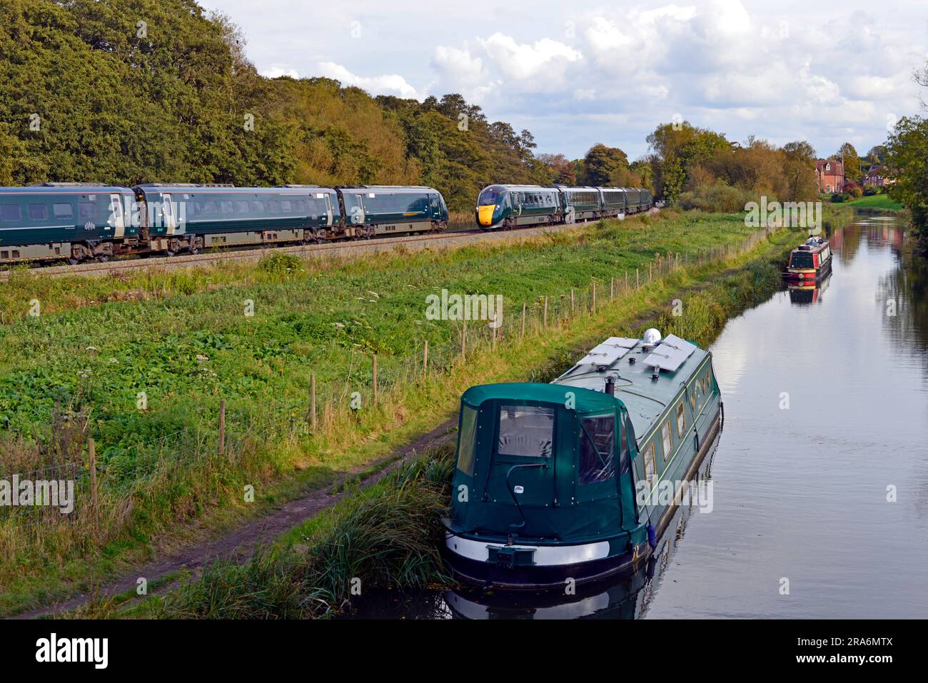 Two Great Western Railway Intercity Express Class 801 trains pass at Kintbury in Berkshire. They are seen alongside the Kennet and Avon Canal. Stock Photo