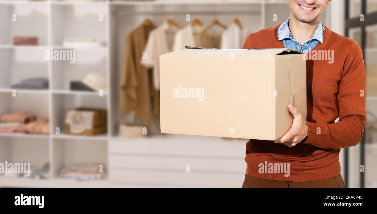 Man lifting cardboard boxes in apartment interior Stock Photo - Alamy