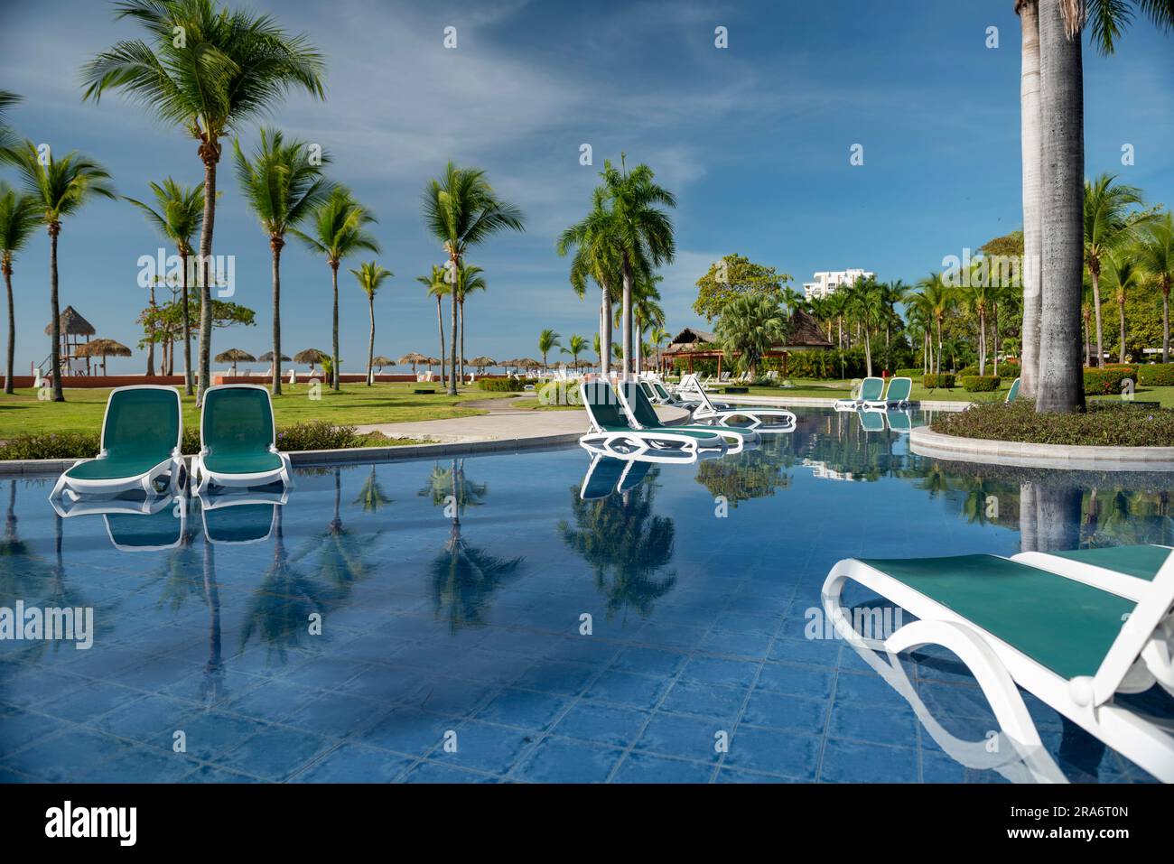 Tanning beds beside swimming pool in tropical resort, Pacific rivera, Panama, Central America - stock photo Stock Photo