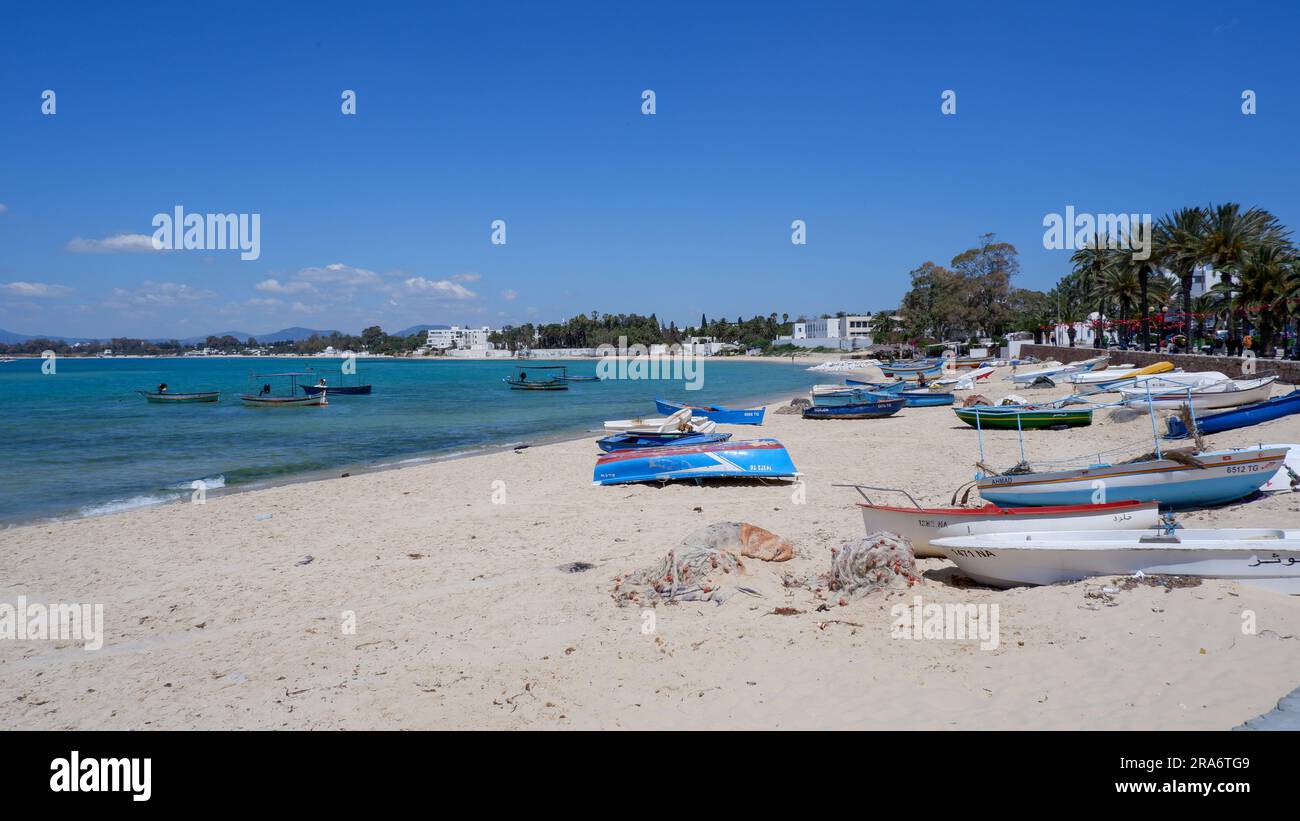 Summer day on the coast of tunisia, small boats on the shore, sky and beautiful tunisian landscape Stock Photo