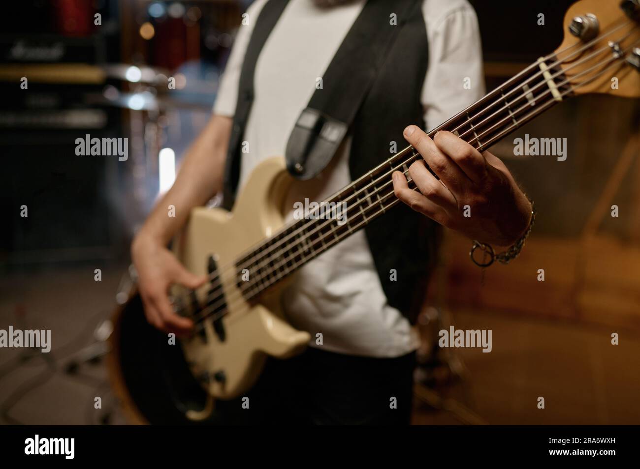 Rock music band performance with cropped shot closeup view on hand of