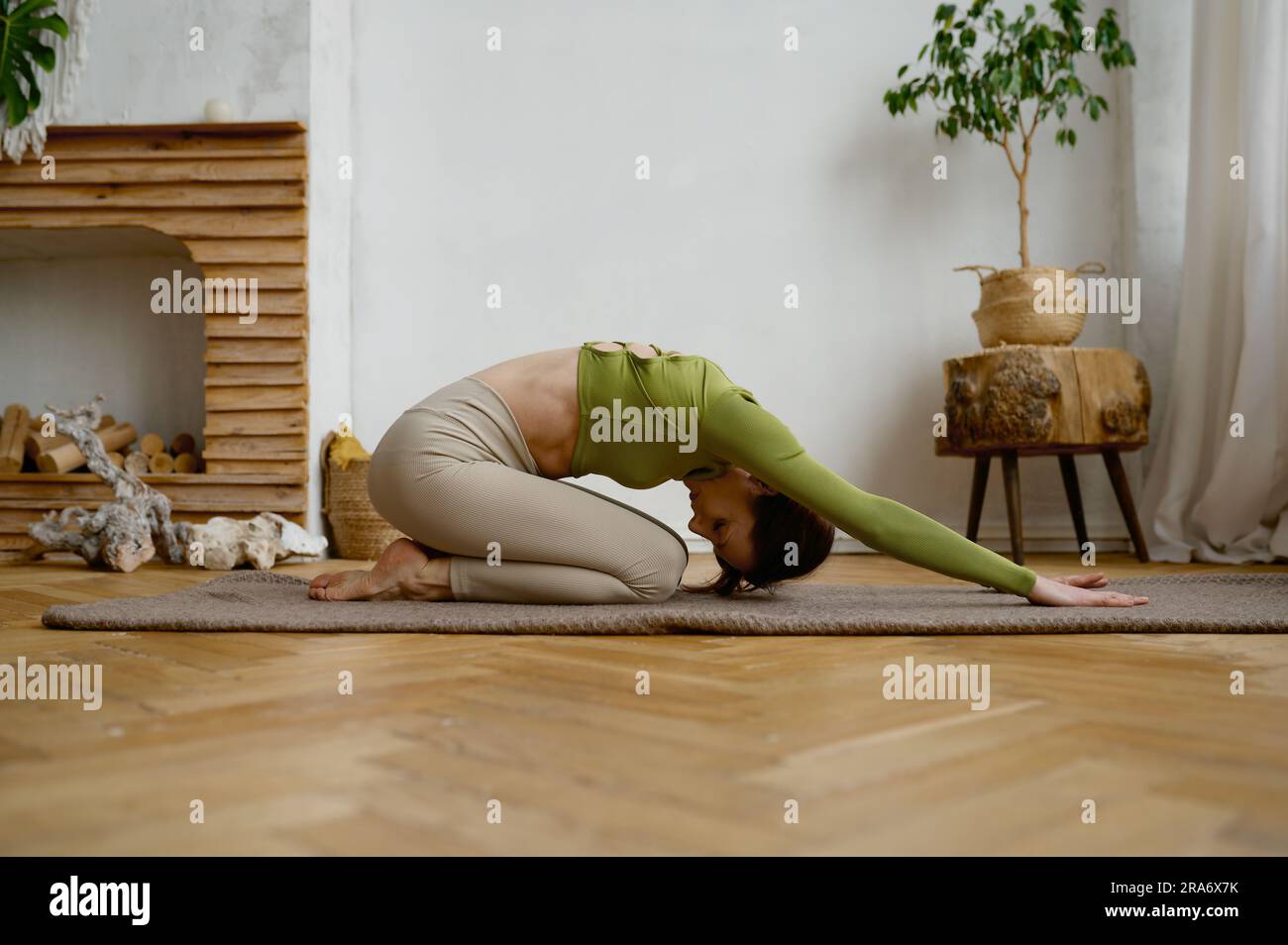 Young yogi woman stretching hi-res stock photography and images - Alamy