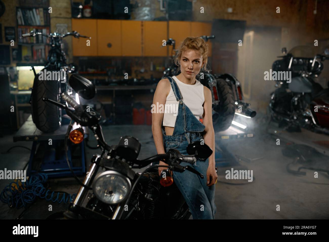 Woman in overalls in garage hi-res stock photography and images - Alamy