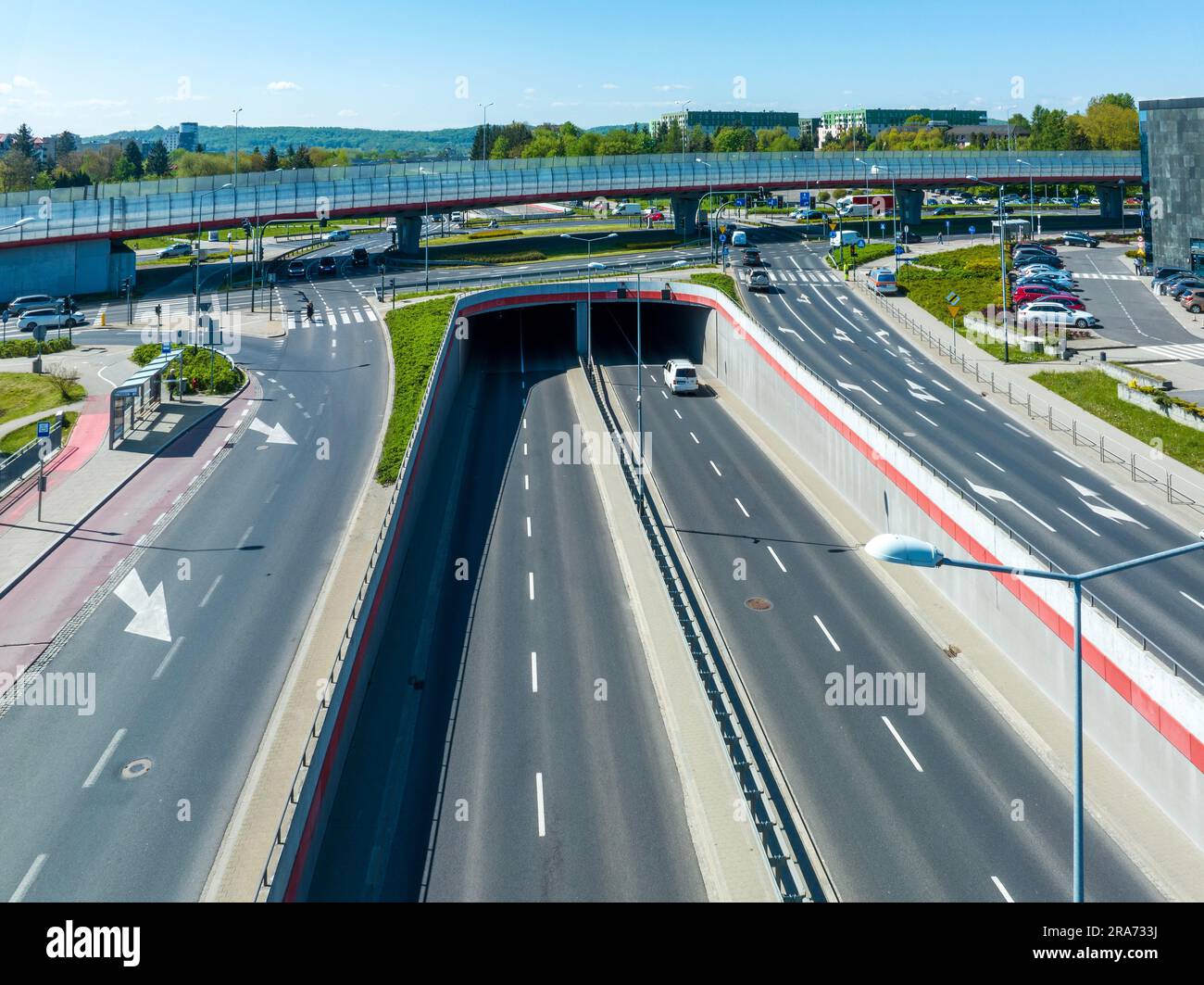 Multilevel city highway junction in Krakow, Poland. One highway on the top level, the second one in the tunnel, the turnaround with traffic lights and Stock Photo