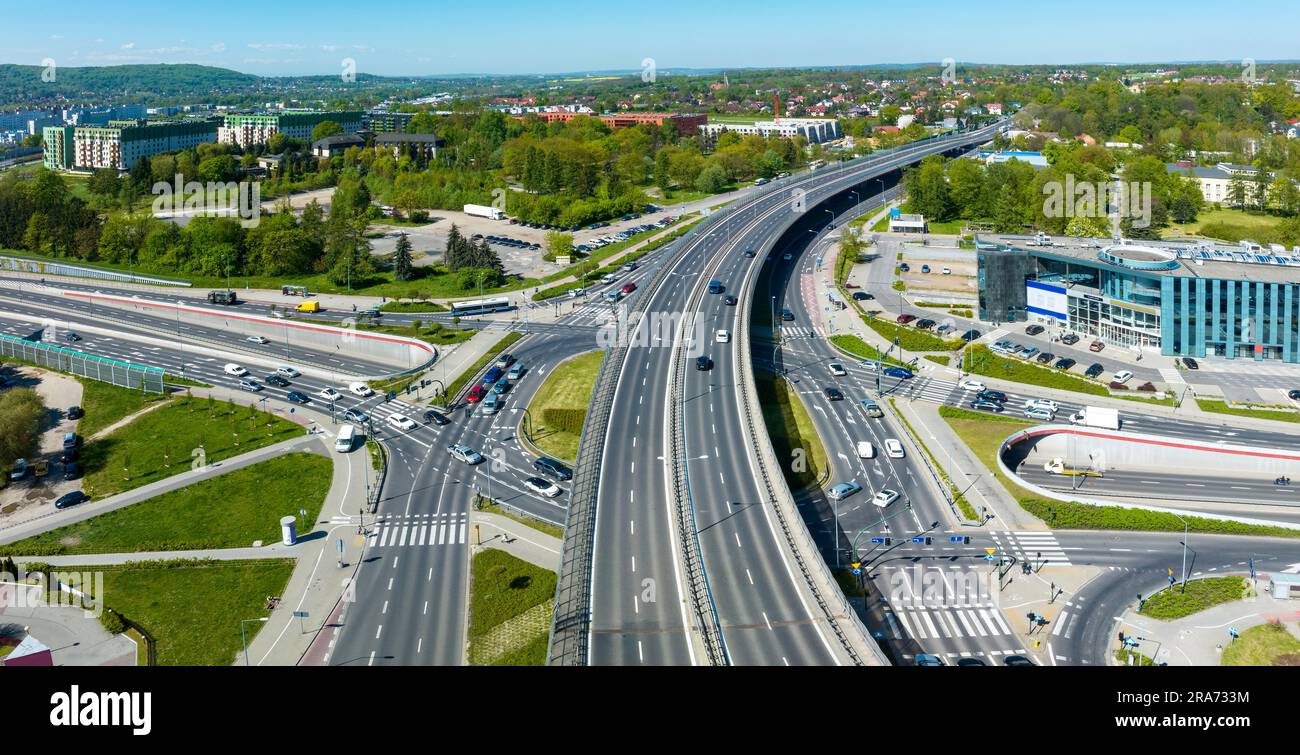 Multilevel city highway junction in Krakow, Poland. One highway on the top level, the second one in the tunnel, the turnaround with traffic lights and Stock Photo
