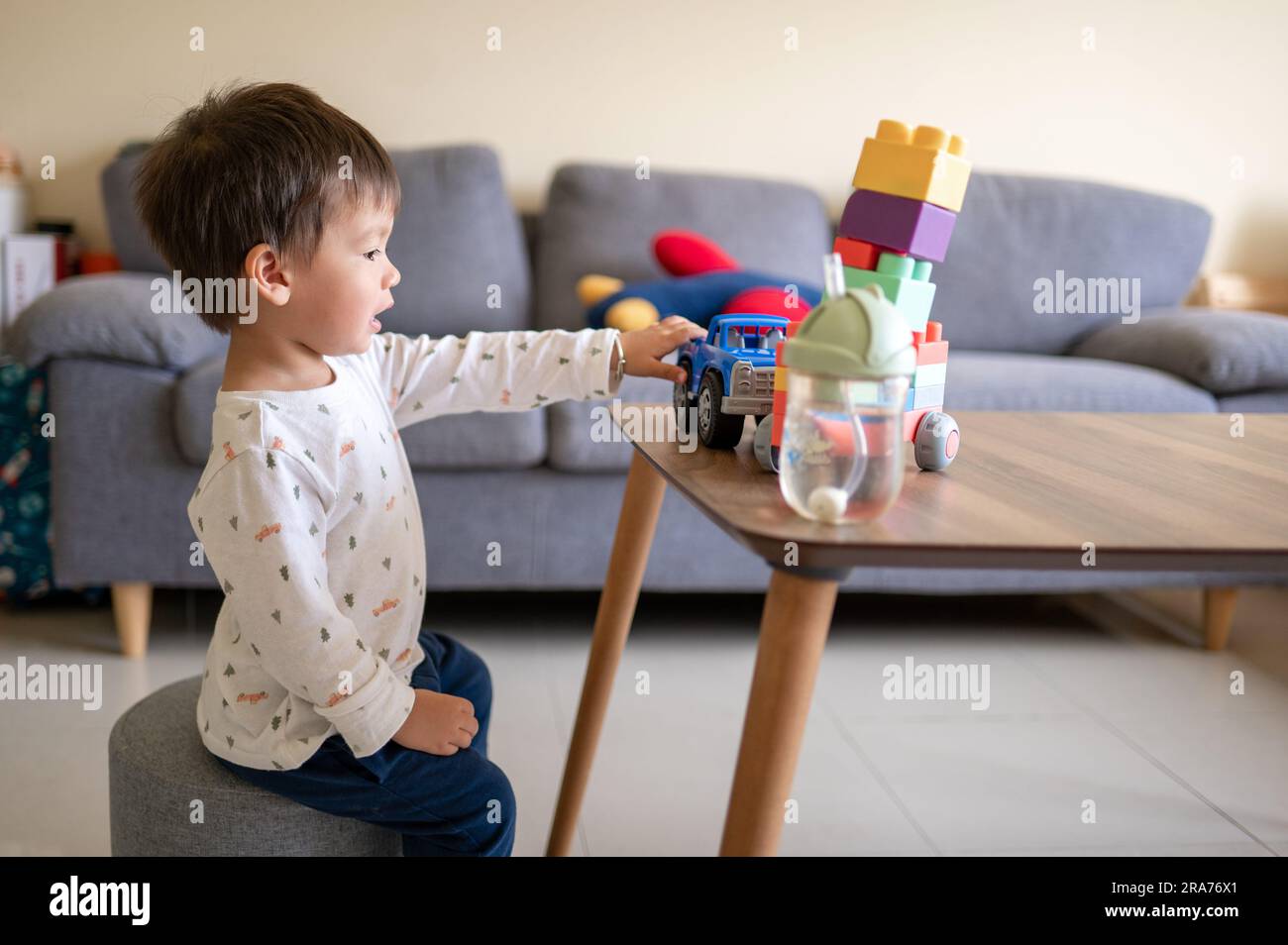 A one and half yearold baby boy of mixed race playing with colorful