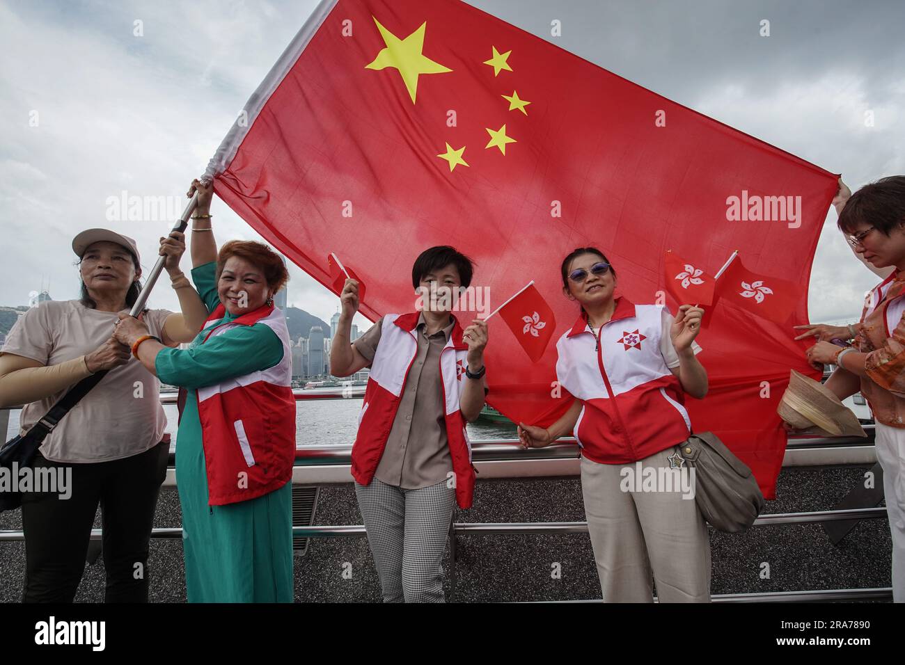 People take photos with both the flags of China and Hong Kong at Tsim ...