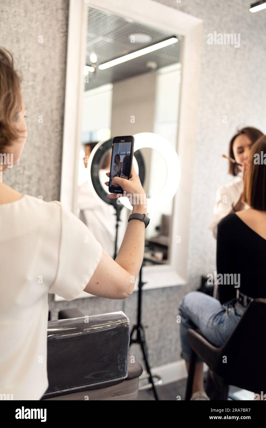 the operator shoots video as they make-up in a beauty salon Stock Photo