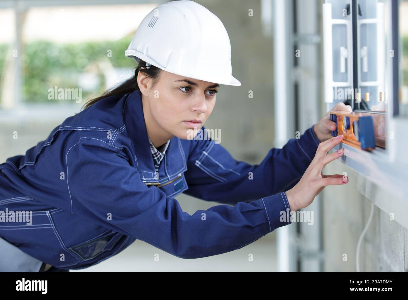 female worker leveling a window Stock Photo - Alamy