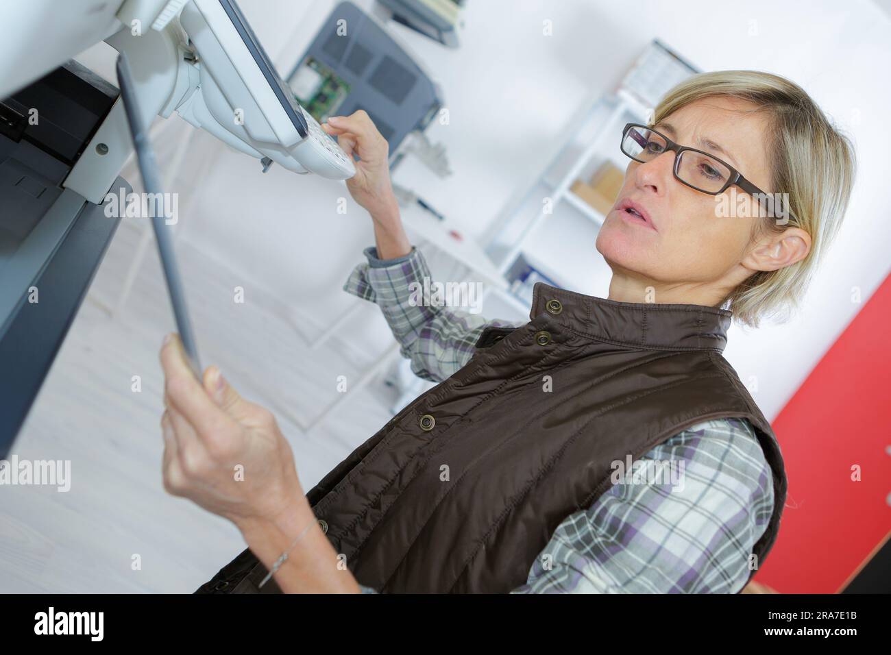 female printing technician input on the codes Stock Photo