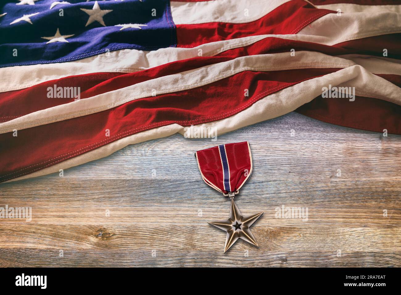 US Bronze Star medal lying on table with American flag Stock Photo