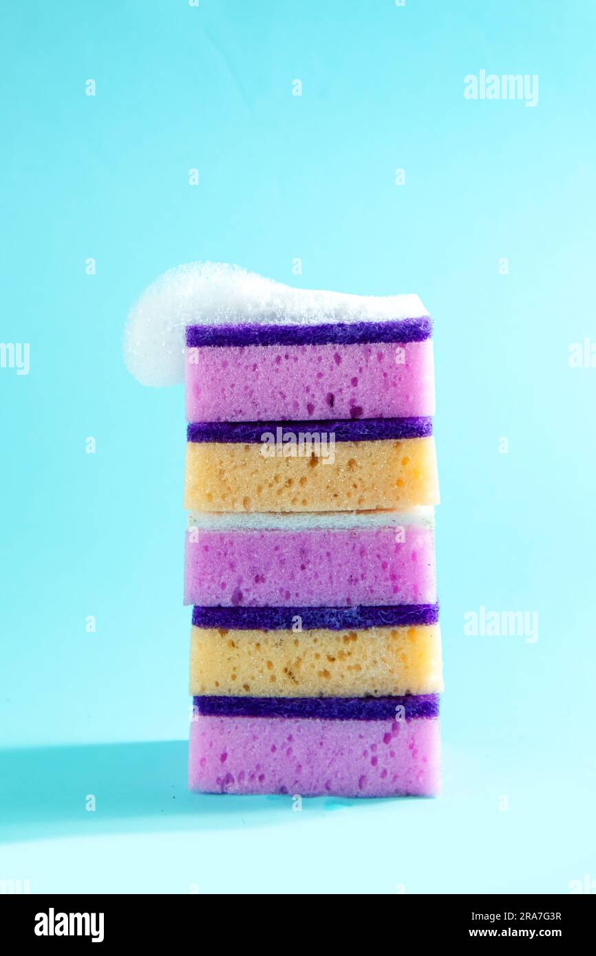 Colored sponges for washing dishes. Blue background Stock Photo Alamy