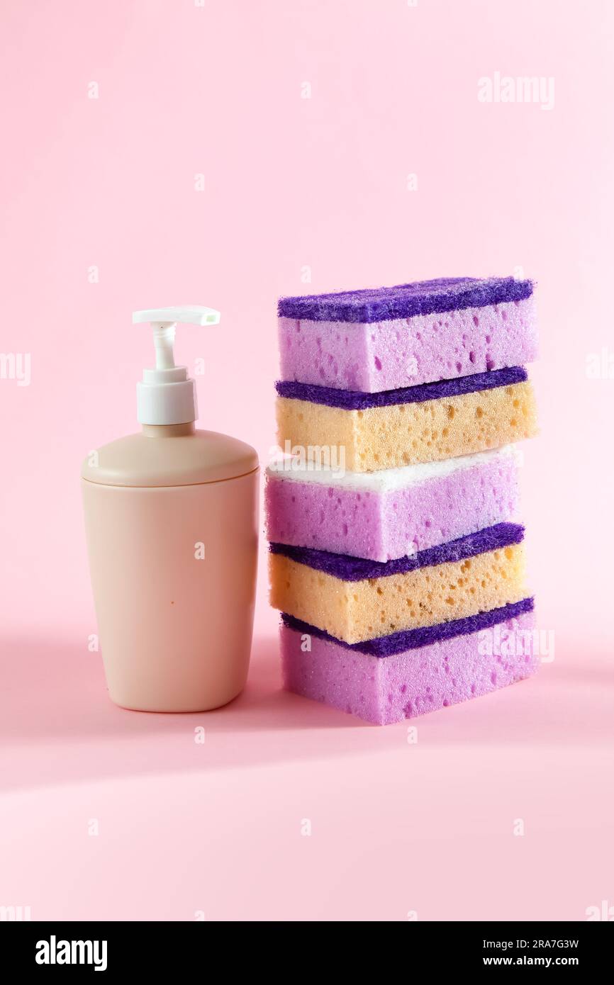 Colored sponges for washing dishes. Pink background. Stock Photo Alamy