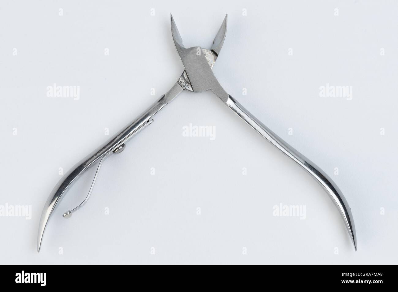 Nail foot open scissors close up view isolated on studio background Stock Photo