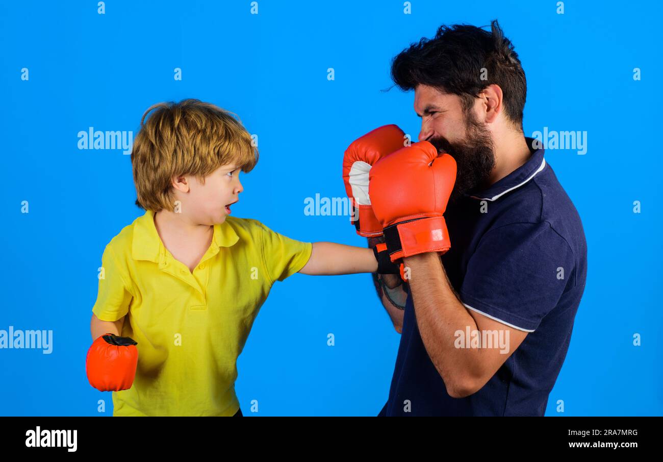 Father and son boxing. Little child boxer with coach at boxing training