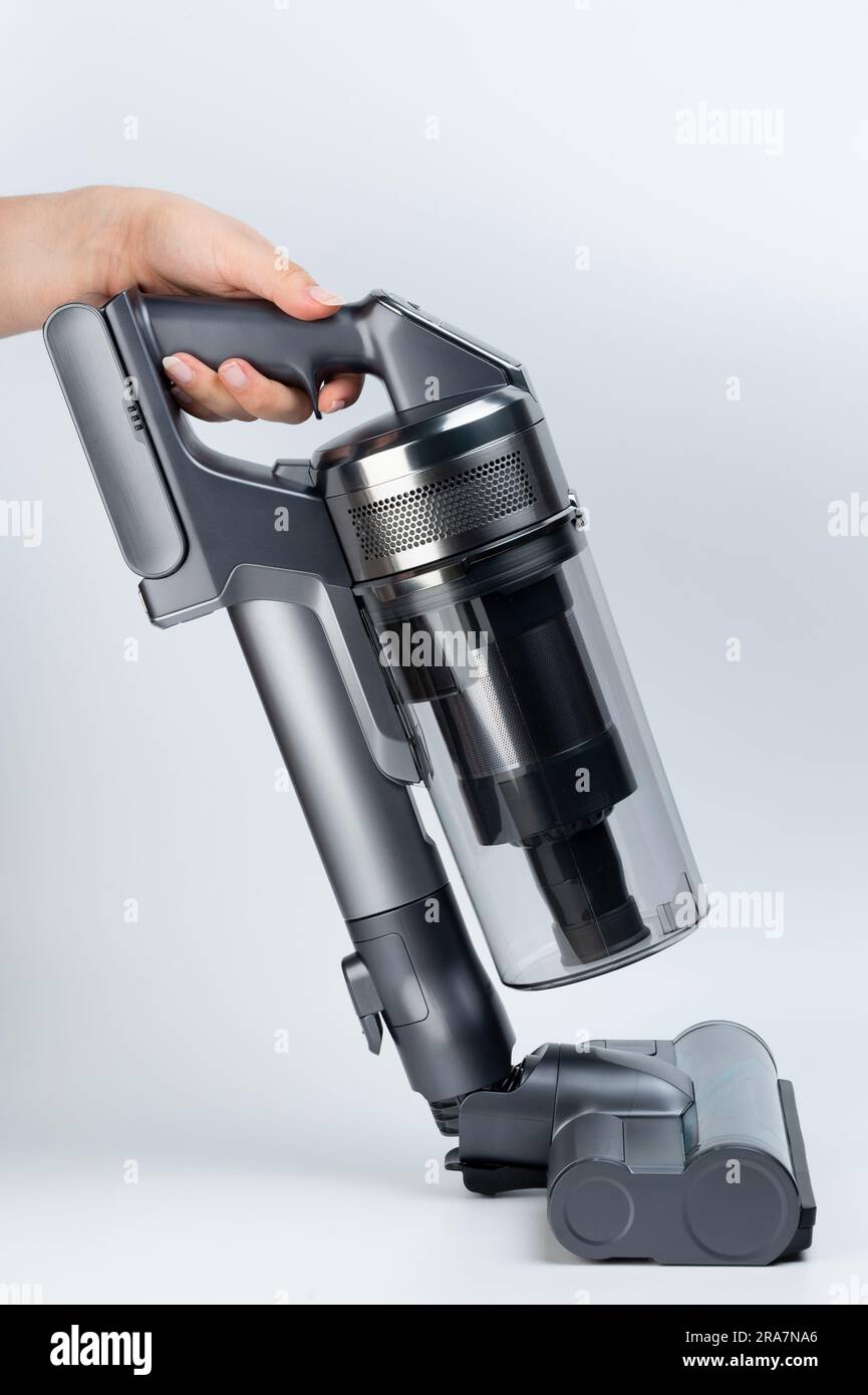 Cleaning floor with vacuum cleaner sweep brush side view isolated on studio background Stock