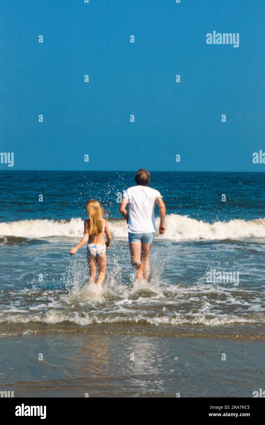 President Jimmy Carter and daughter, Amy Carter, run in the surf at Sea