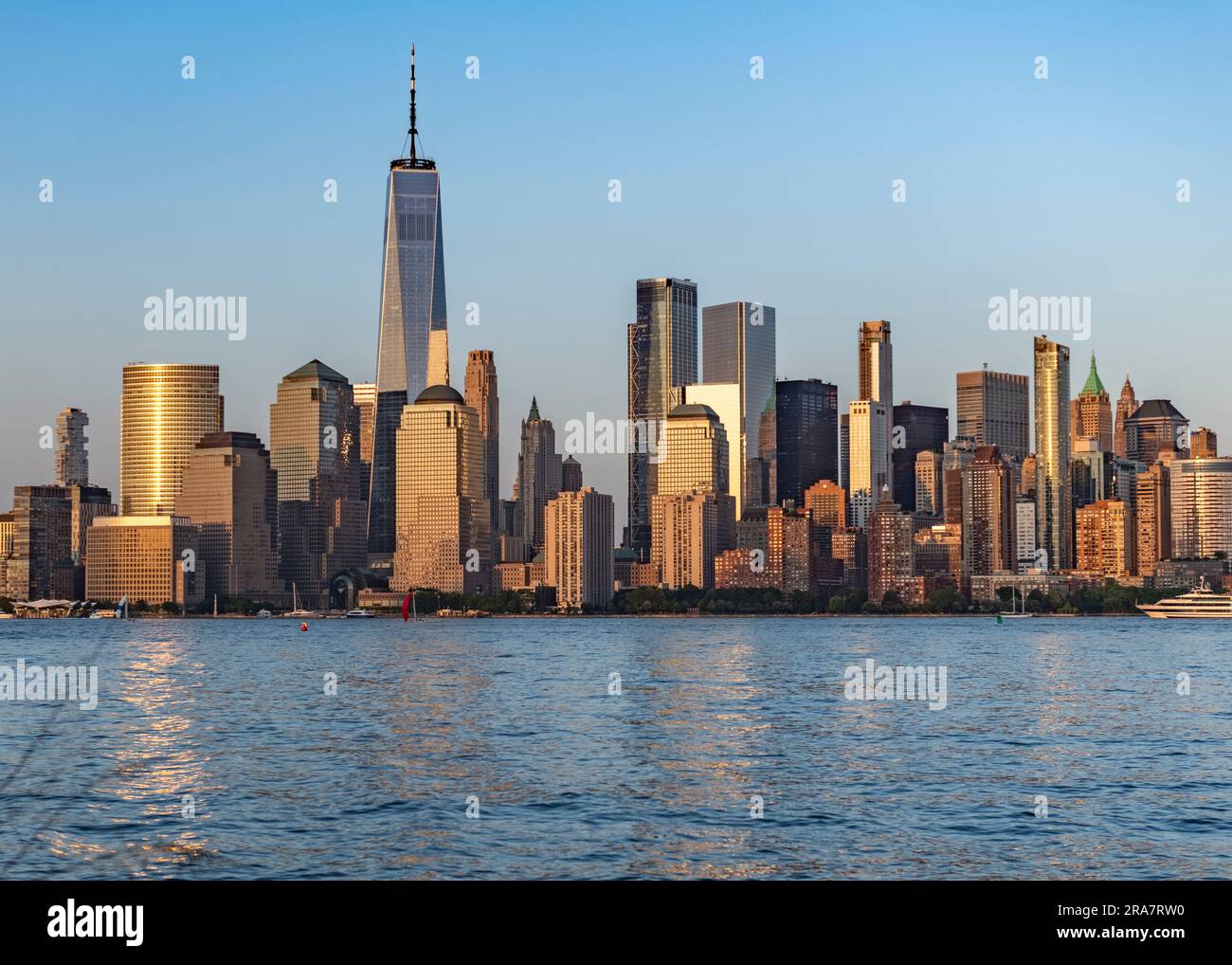 Downtown Manhattan skyline New York City with Hudson River in foreground at sunset Stock Photo