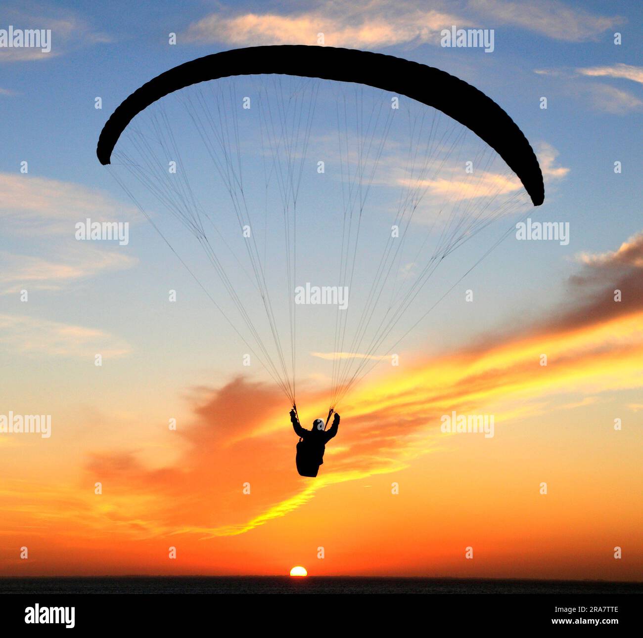 Hang Glider, against sunset sky, England Stock Photo