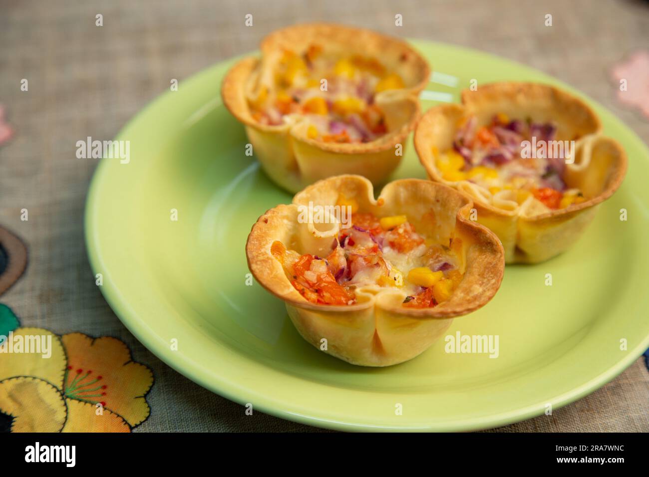 Baked pastry cup filled with cheese and tomatoes, a delectable and savory appetizer or snack Stock Photo