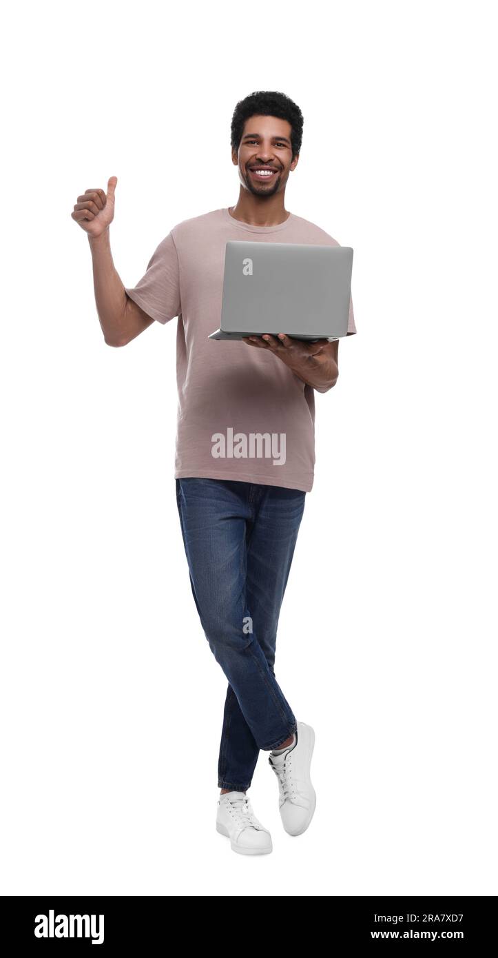 Happy man with laptop showing thumb up on white background Stock Photo