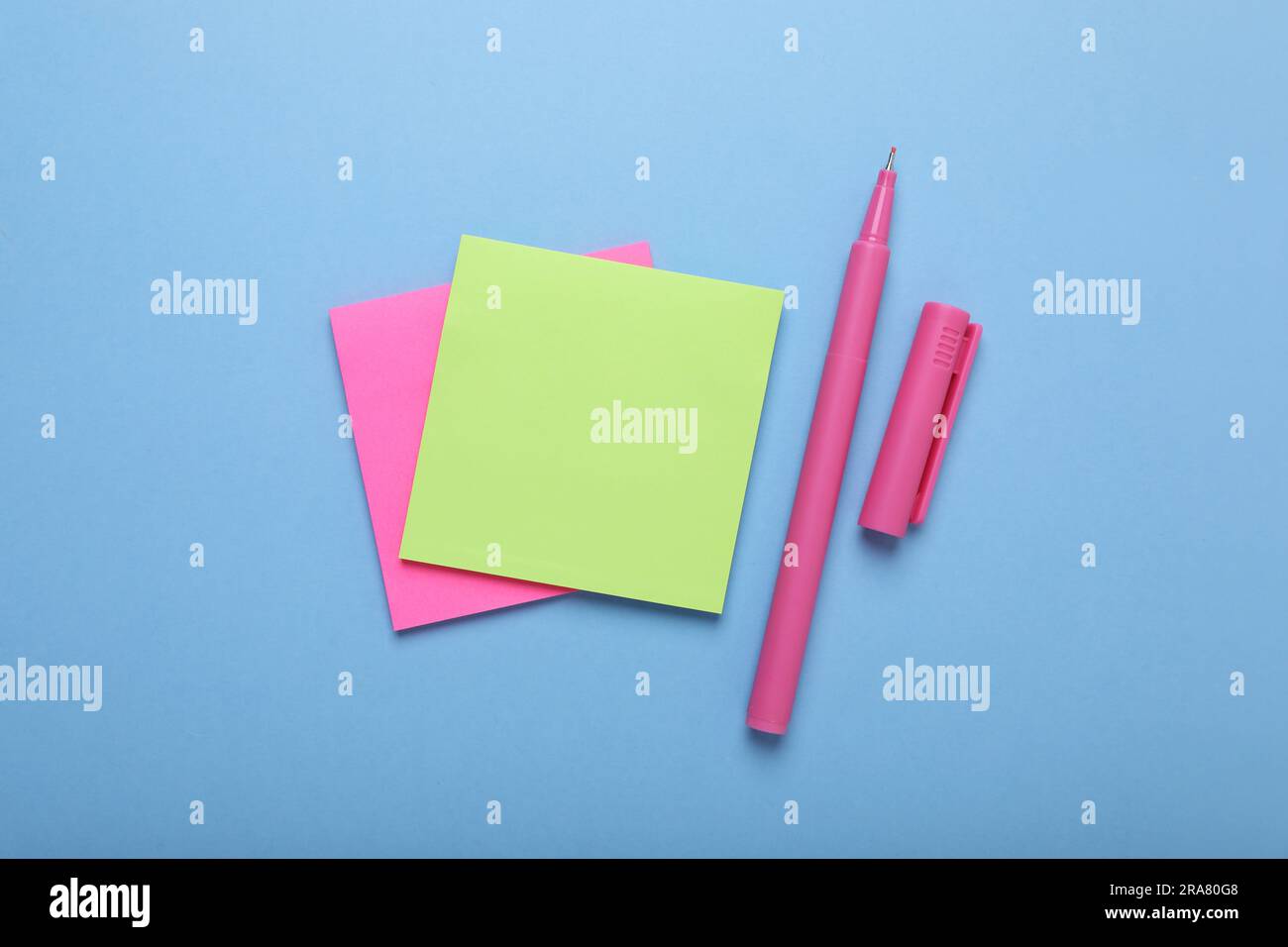 Paper notes and color marker on light blue background, flat lay Stock ...
