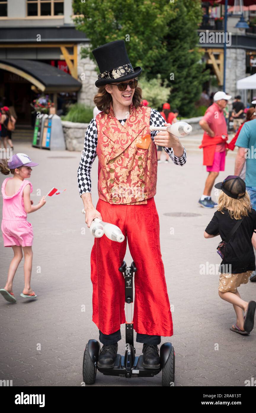 Street Entertainers and tourists in the Whistler Village on Canada Day, 2023.  Whistler BC, Canada. Stock Photo