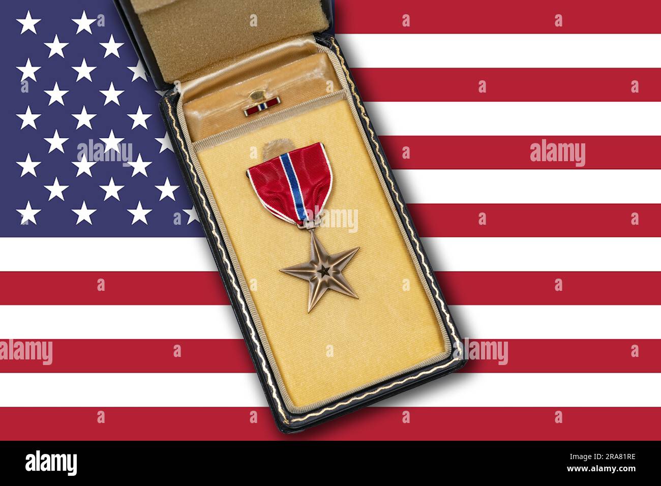 US Air Force Bronze Star medal lying on table with American flag Stock Photo