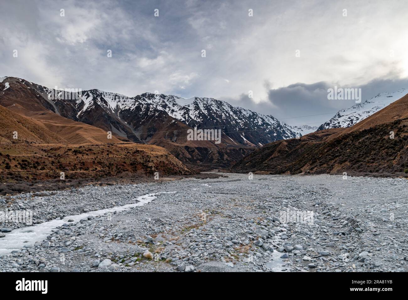 Scenic view along the Mount Cook Road alongside with snow capped Southern Alps basking in the late winter evening light. Best road trip route. Stock Photo