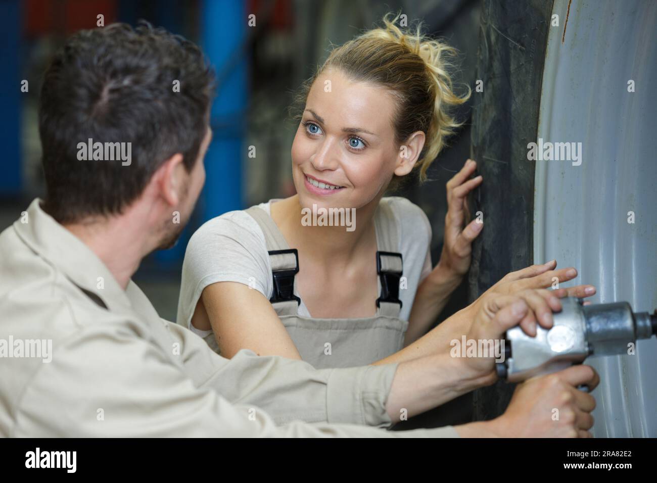 experienced female auto mechanic checking tires Stock Photo