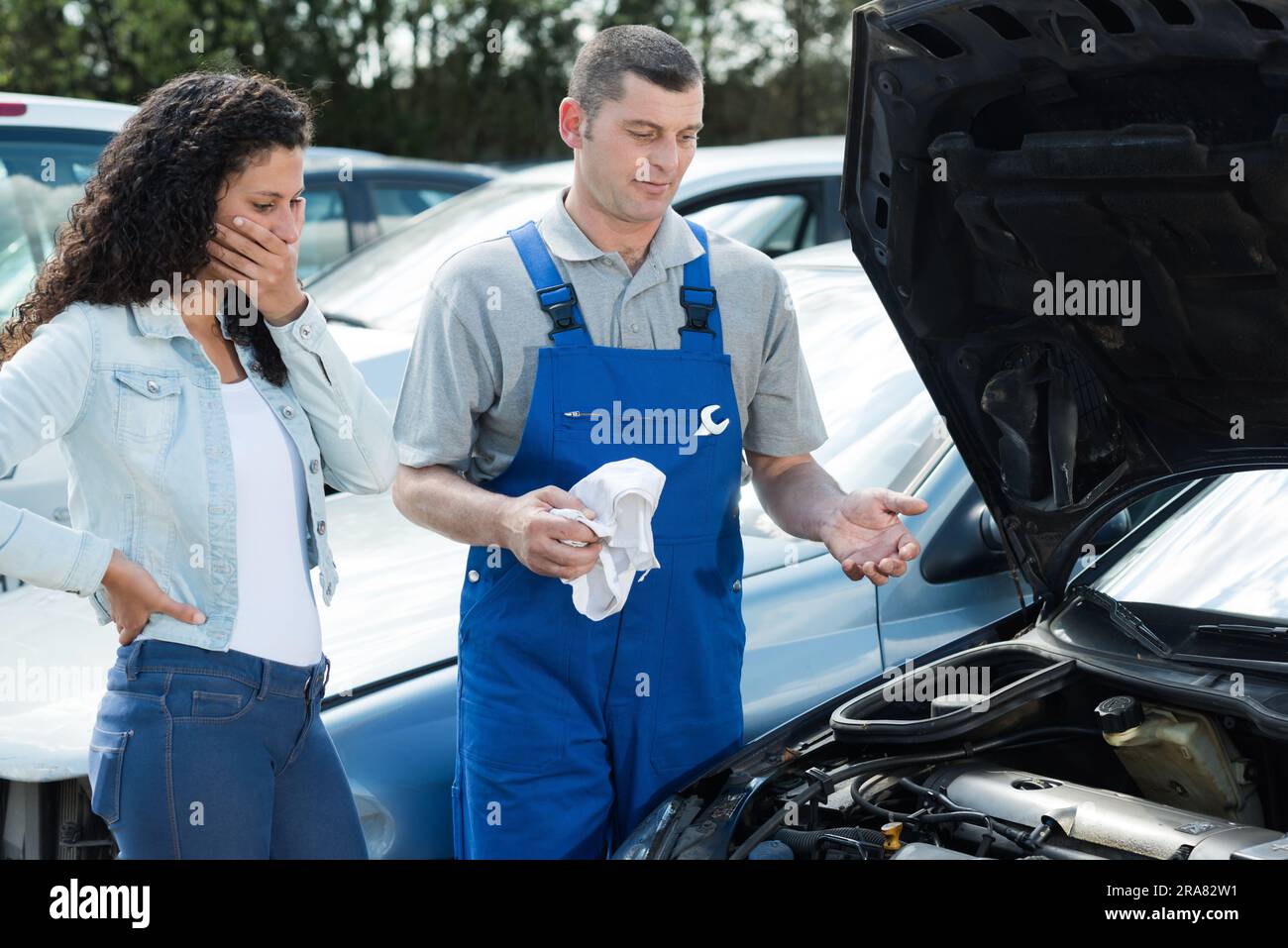 mechanic explains customer the car engine problem Stock Photo Alamy
